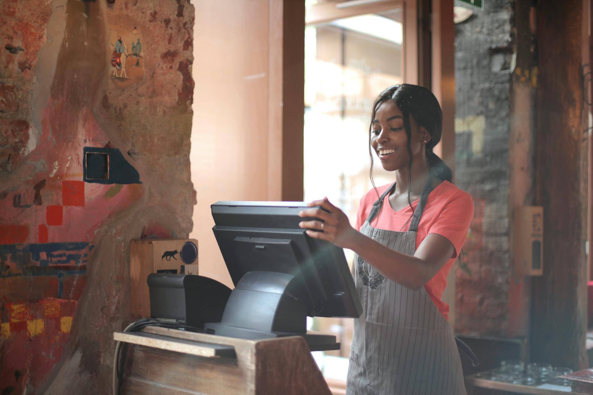Restaurant staff using t’order on a table-mounted tablet, syncing with Clover POS